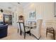 Tasteful dining room with seating for six, wainscoting, decorative art, and neutral decor at 13136 N Marsh Dr, Port Charlotte, FL 33953