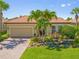 Charming single-Gathering home with a well-manicured lawn, beautiful landscaping, and a two-car garage at 13136 N Marsh Dr, Port Charlotte, FL 33953