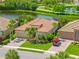 A beautiful one-story home with a paver driveway and lush tropical landscaping near a serene pond at 13136 N Marsh Dr, Port Charlotte, FL 33953