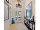 Bright foyer featuring tile floors, a decorative mirror, and an elegant console table at 13136 N Marsh Dr, Port Charlotte, FL 33953