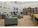 Inviting library space with comfortable seating, bookshelves, and natural light at 13136 N Marsh Dr, Port Charlotte, FL 33953