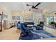Open-concept living area with tile flooring, tray ceilings, comfortable seating, and seamless access to the outdoors at 13136 N Marsh Dr, Port Charlotte, FL 33953