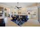 Inviting living room featuring tile floors, modern furniture, and an open layout connecting to the kitchen at 13136 N Marsh Dr, Port Charlotte, FL 33953