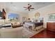 Relaxing main bedroom with seating area, ceiling fan, and natural light from the window at 13136 N Marsh Dr, Port Charlotte, FL 33953