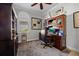 Well-appointed home office featuring custom built-ins, ample natural light, and a cozy workspace at 13136 N Marsh Dr, Port Charlotte, FL 33953