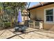 Outdoor patio with dining area and built-in grill, perfect for al fresco dining and entertaining at 13136 N Marsh Dr, Port Charlotte, FL 33953