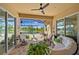 A covered patio with comfortable seating offers views of the pool and lush landscaping at 13136 N Marsh Dr, Port Charlotte, FL 33953