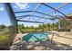 A screened-in pool offers a serene outdoor retreat with a lake view at 13136 N Marsh Dr, Port Charlotte, FL 33953