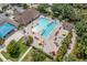 Aerial view of the large community pool, lounge seating, mature trees, and ample space for outdoor relaxation at 13136 N Marsh Dr, Port Charlotte, FL 33953
