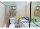 Functional bathroom featuring decorative shelves, a neutral shower curtain, and a single sink vanity at 1389 Hinton St, Port Charlotte, FL 33952