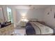 Bright bedroom offering a comfortable bed with a nightstand, and access to the en-suite bathroom at 1389 Hinton St, Port Charlotte, FL 33952