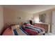 Shared bedroom featuring two beds with pastel striped bedding, a mirrored vanity, and neutral walls at 1389 Hinton St, Port Charlotte, FL 33952