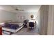 Cozy bedroom featuring a ceiling fan, a comfortable bed, and a functional workspace at 1389 Hinton St, Port Charlotte, FL 33952