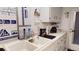 Functional kitchen with white cabinets, a double sink, and efficient layout, offering a practical cooking space at 1389 Hinton St, Port Charlotte, FL 33952