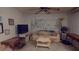 Relaxing living room with comfortable seating, a large television, and a tranquil mural, ideal for unwinding at 1389 Hinton St, Port Charlotte, FL 33952