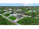 Picturesque aerial shot of a waterfront house surrounded by lush greenery and neighborhood homes at 14166 Fort Worth Cir, Port Charlotte, FL 33981