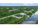 A stunning house situated on the water, showcasing a well-manicured lawn and boat dock at 14166 Fort Worth Cir, Port Charlotte, FL 33981