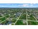 Aerial view of a residential community with waterfront properties along winding canals and tree-lined streets at 14166 Fort Worth Cir, Port Charlotte, FL 33981