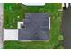Overhead view of a dark gray roof, landscaped grounds, and waterside location at 14166 Fort Worth Cir, Port Charlotte, FL 33981