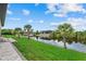 Waterfront backyard with lush greenery and tropical landscaping for serene outdoor enjoyment at 14166 Fort Worth Cir, Port Charlotte, FL 33981