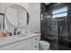 Modern bathroom with a glass shower, black marble, and a round gold mirror at 14166 Fort Worth Cir, Port Charlotte, FL 33981