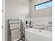 Bright bathroom featuring modern tub with a window, sleek fixtures, and a minimalist design at 14166 Fort Worth Cir, Port Charlotte, FL 33981