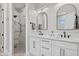 Contemporary bathroom with dual vanities, modern fixtures, marble accents, and a walk-in shower at 14166 Fort Worth Cir, Port Charlotte, FL 33981