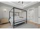 Calm bedroom featuring wood floors, a canopy bed, with outside views and natural light from the windows at 14166 Fort Worth Cir, Port Charlotte, FL 33981