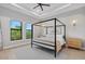 Serene bedroom with a canopy bed, tray ceiling, and plenty of natural light from large windows at 14166 Fort Worth Cir, Port Charlotte, FL 33981