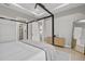 Spacious bedroom featuring wood floors, a canopy bed, and access to a marble bathroom at 14166 Fort Worth Cir, Port Charlotte, FL 33981