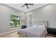 Bedroom featuring a window with a palm tree view, neutral walls, and hardwood floors at 14166 Fort Worth Cir, Port Charlotte, FL 33981