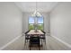 Dining room showcasing a stylish table with modern chairs, a contemporary chandelier, and scenic outdoor views at 14166 Fort Worth Cir, Port Charlotte, FL 33981