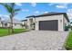 Contemporary home featuring a spacious driveway, a two-car garage, and well-maintained landscaping at 14166 Fort Worth Cir, Port Charlotte, FL 33981