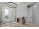 Entryway with a modern chandelier, double glass front doors, and a console table at 14166 Fort Worth Cir, Port Charlotte, FL 33981