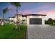Charming home displaying an attached two-car garage and impeccable landscaping creating a welcoming curb appeal at 14166 Fort Worth Cir, Port Charlotte, FL 33981