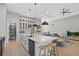 Open-concept kitchen with a spacious island, pendant lighting, seating, and a seamless transition to the living area at 14166 Fort Worth Cir, Port Charlotte, FL 33981