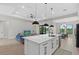 Spacious open floor plan with a kitchen island and barstool seating, connecting the living and dining areas at 14166 Fort Worth Cir, Port Charlotte, FL 33981