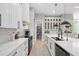 Bright, open kitchen with white cabinetry, quartz countertops, stainless steel appliances, and an island at 14166 Fort Worth Cir, Port Charlotte, FL 33981