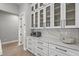 Kitchen with white cabinets, glass front upper cabinets, quartz countertops, and stainless steel appliances at 14166 Fort Worth Cir, Port Charlotte, FL 33981