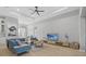 Spacious open-concept living area with a comfortable couch, television, and a view into the entryway at 14166 Fort Worth Cir, Port Charlotte, FL 33981