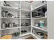 Organized pantry with white shelving, ample storage for kitchen essentials, and a built-in microwave at 14166 Fort Worth Cir, Port Charlotte, FL 33981