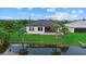A view of the home and waterfront, showcasing the well-manicured lawn at 14166 Fort Worth Cir, Port Charlotte, FL 33981