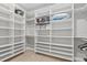Walk-in closet with custom shelving, providing ample storage and organization solutions at 14166 Fort Worth Cir, Port Charlotte, FL 33981