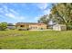 Spacious backyard with lush green grass, storage shed, and ample space for activities at 1478 Harmony Dr, Port Charlotte, FL 33952