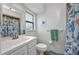 Bright bathroom with stylish shower curtain, white vanity, and coordinated decor at 1478 Harmony Dr, Port Charlotte, FL 33952
