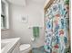 Bright bathroom with stylish shower curtain, white vanity, and coordinated decor at 1478 Harmony Dr, Port Charlotte, FL 33952