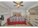 Bedroom featuring wood floors, tv, and a comfortable queen-size bed at 1478 Harmony Dr, Port Charlotte, FL 33952