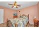 Comfortable bedroom with a patterned bedspread, wooden furnishings, and a ceiling fan at 1478 Harmony Dr, Port Charlotte, FL 33952