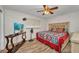 Inviting bedroom featuring wood floors, tv, and a comfortable queen-size bed at 1478 Harmony Dr, Port Charlotte, FL 33952