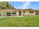 Inviting single-story home with green lawn, decorative shutters, and a welcoming front door at 1478 Harmony Dr, Port Charlotte, FL 33952